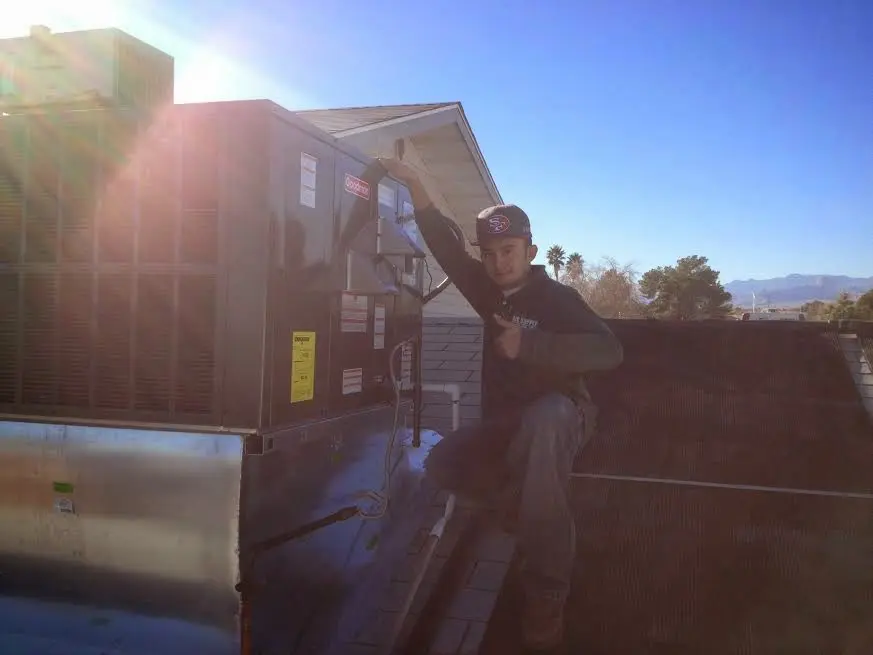 HVAC technician performing HVAC Inspection on a rooftop unit in Bayou Cane